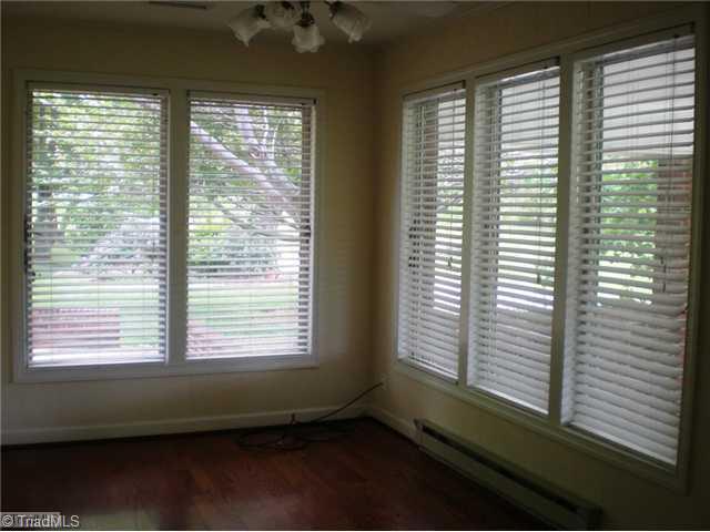 8624 Hudson James Road Summerfield, NC 27358 - Photo 11 of 15 Sunroom. Sunroom located off the den has hardwoods, ceiling fan and wide blinds.