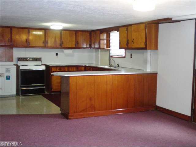 8624 Hudson James Road Summerfield, NC 27358 - Photo 12 of 15 Other. Daylight basement complete with kitchen, den, dining area, full bath, bedroom, closets and unfinished storage area.