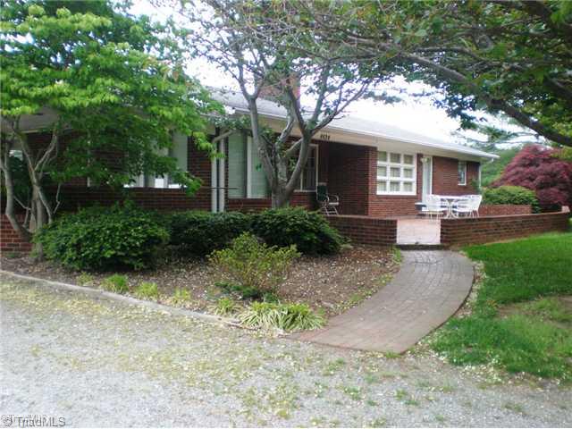 8624 Hudson James Road Summerfield, NC 27358 - Photo 6 of 15 Exterior Front. Walkway leads to two front entrances. Large windows allow interior views of the lovely front yard