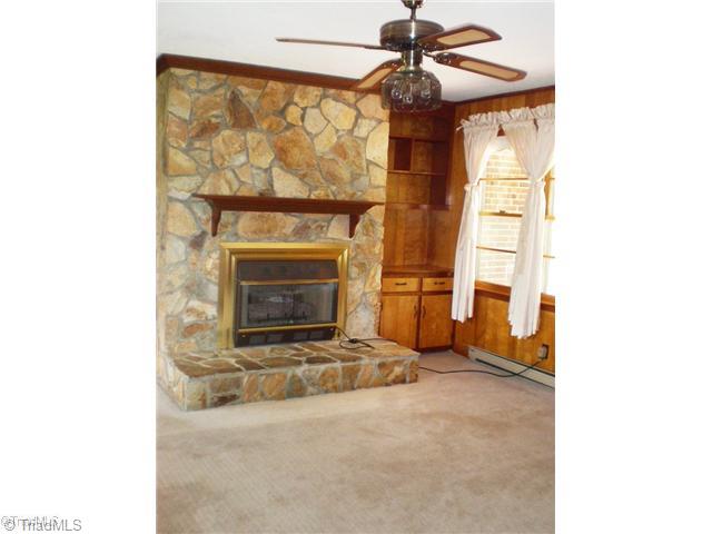 8624 Hudson James Road Summerfield, NC 27358 - Photo 10 of 15 Den/Family/Great Room. Den/Family room with stone fireplace, gas heater insert, built-ins and dual windows overlooking the lovely front yard and patio area.