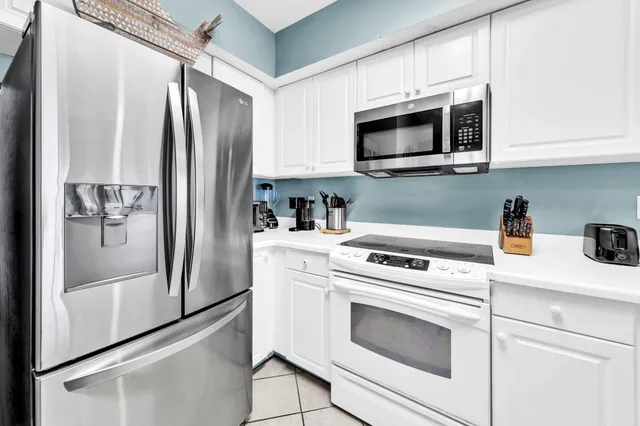 a kitchen with stainless steel appliances a sink stove and cabinets