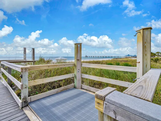 a view of a porch with furniture and a yard