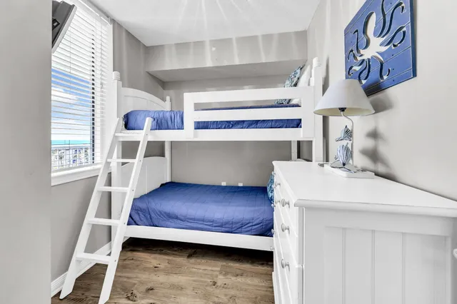 a kitchen with a sink a stove and a painting