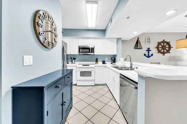 a kitchen with a sink and a refrigerator