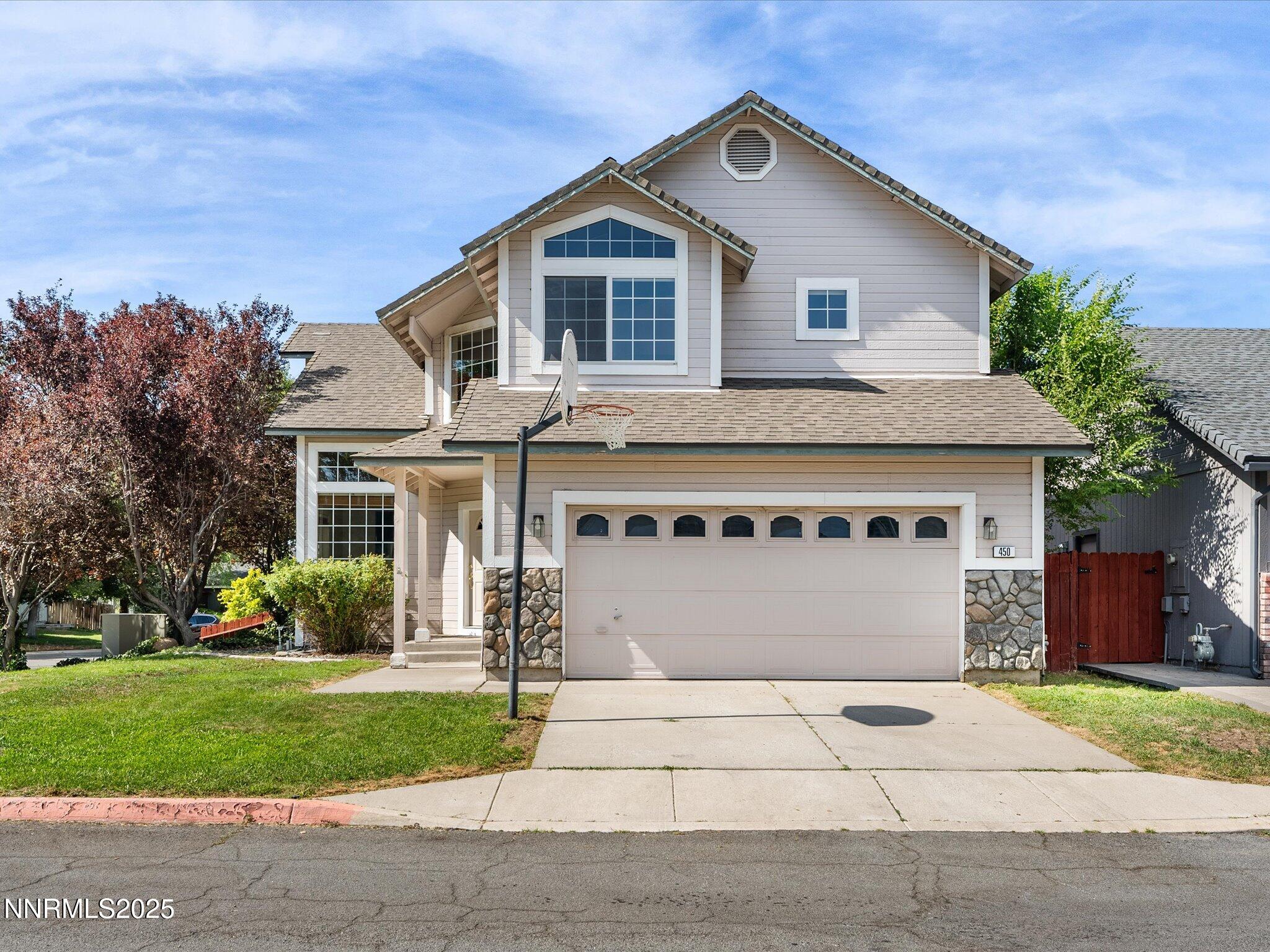 450 Len Circle Reno, NV 89511 - Photo 2 of 44 a front view of a house with a garden and trees