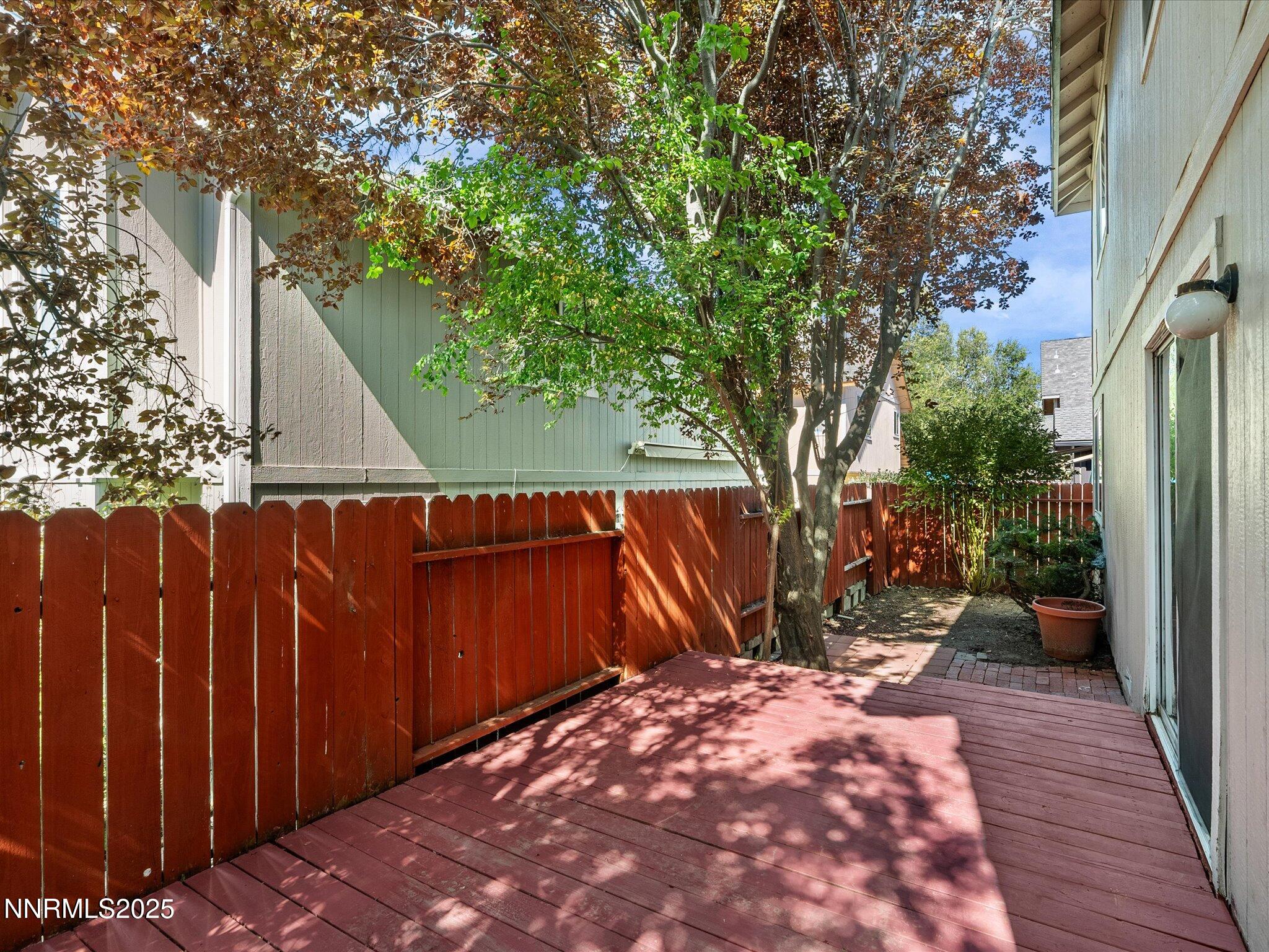 450 Len Circle Reno, NV 89511 - Photo 41 of 44 a view of backyard with wooden fence and a large tree