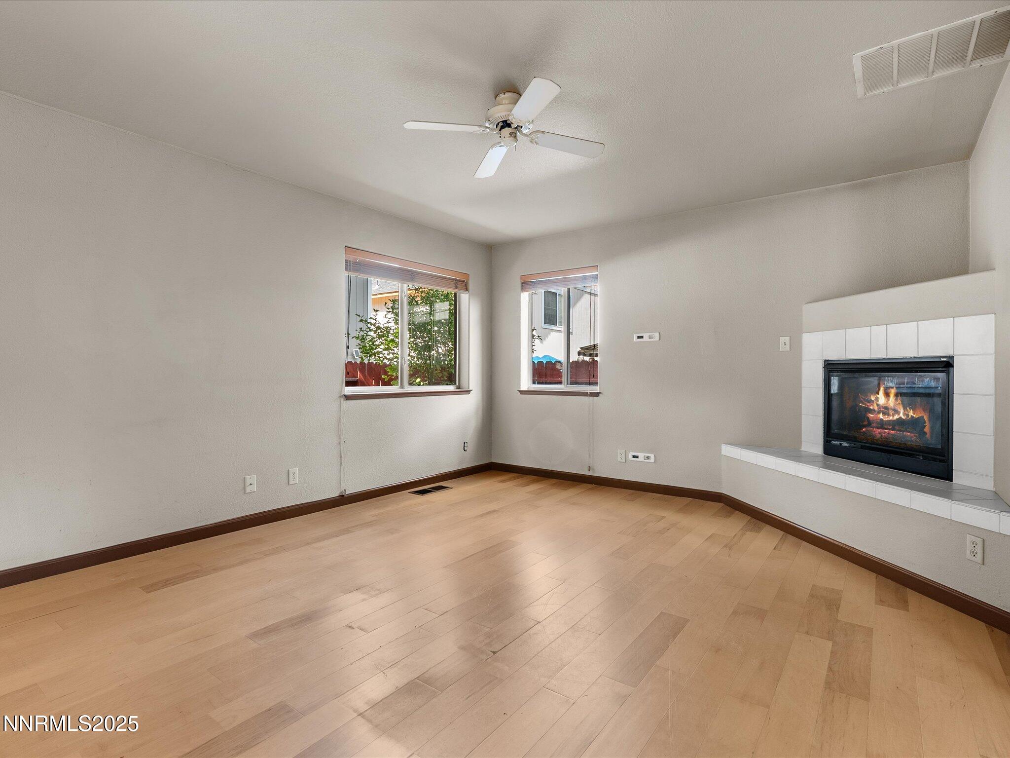 450 Len Circle Reno, NV 89511 - Photo 8 of 44 an empty room with windows and fireplace