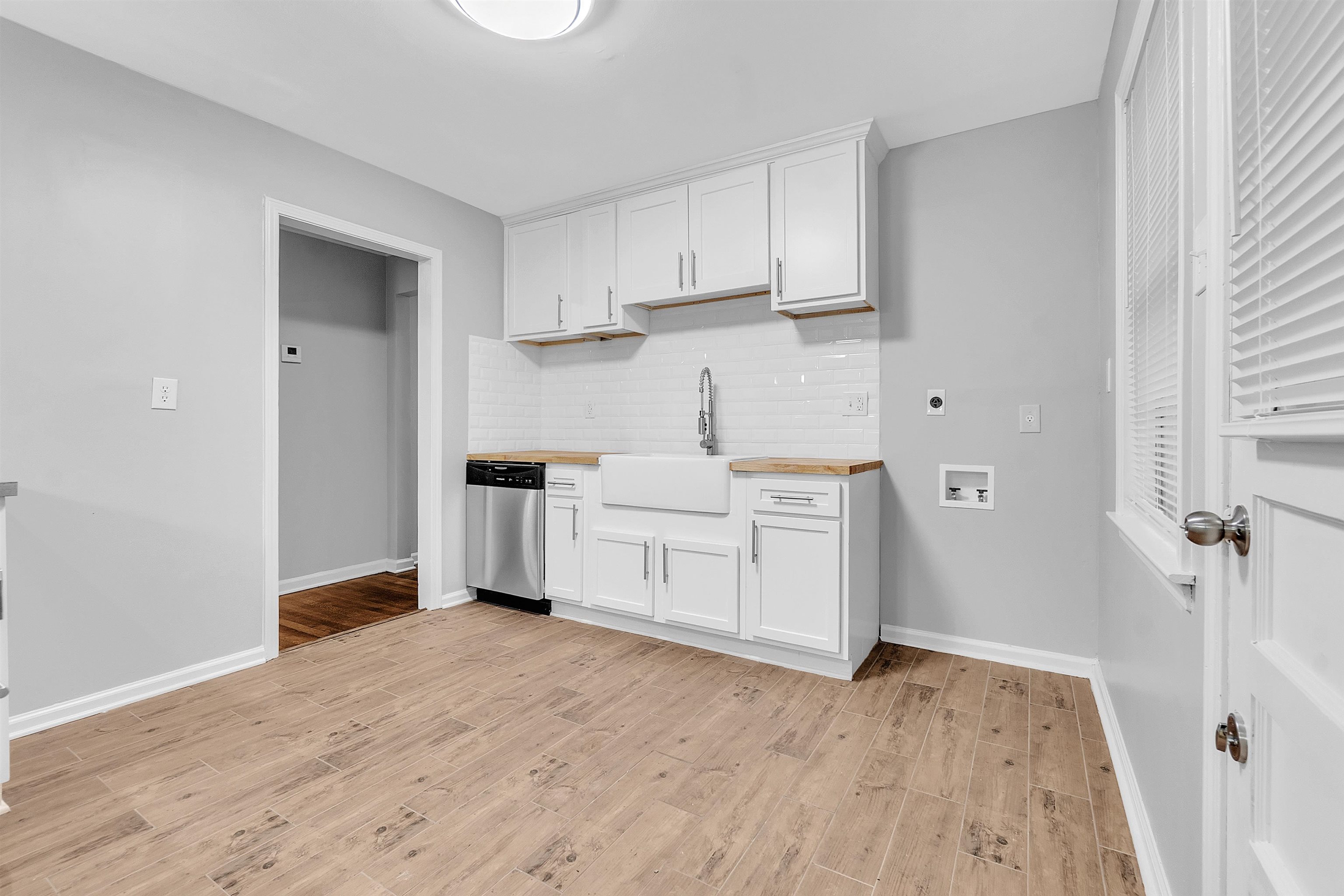 4155 Coventry Drive Memphis, TN 38127 - Photo 11 of 20 a kitchen with white cabinets and wooden floor