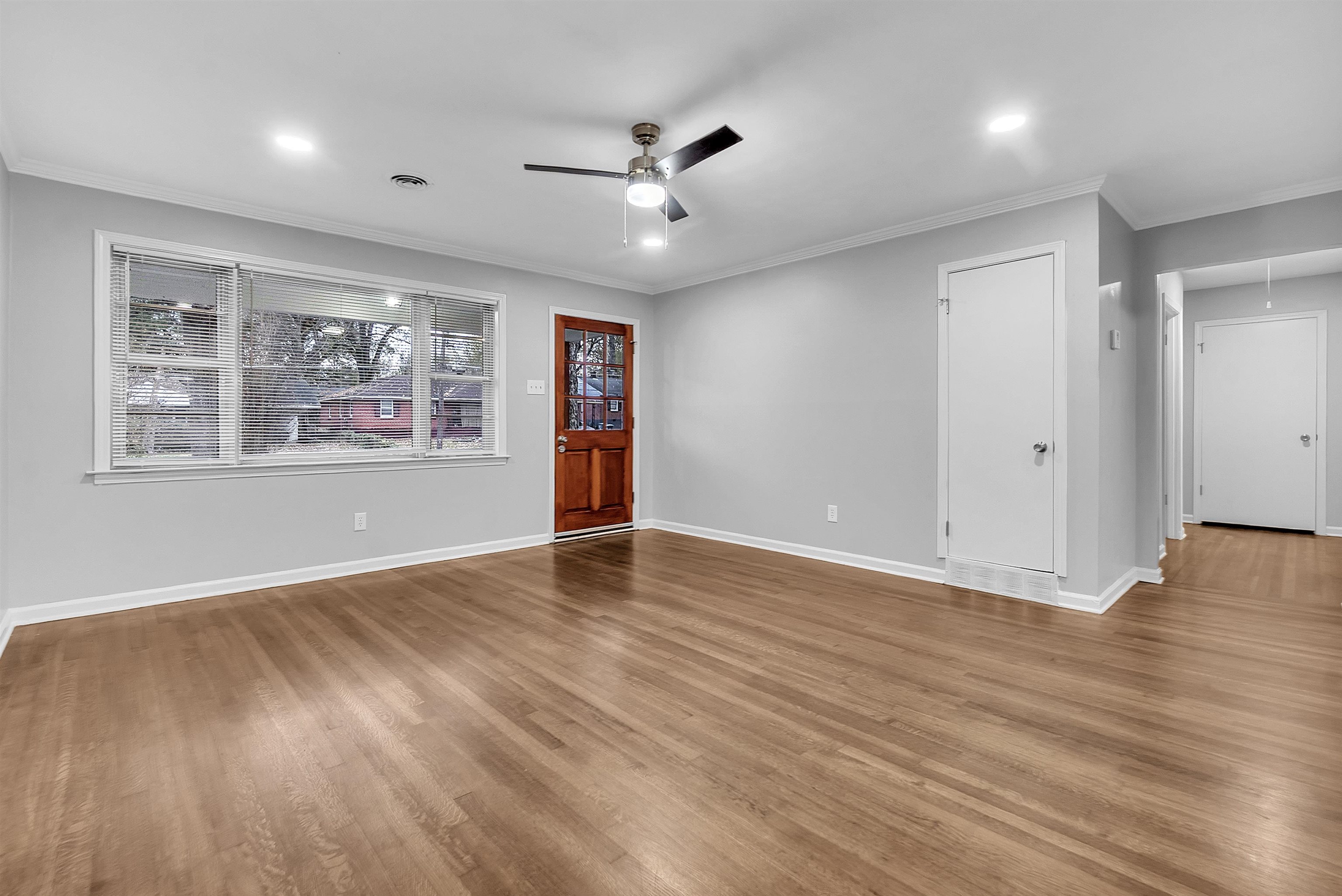 4155 Coventry Drive Memphis, TN 38127 - Photo 6 of 20 an empty room with wooden floor and windows
