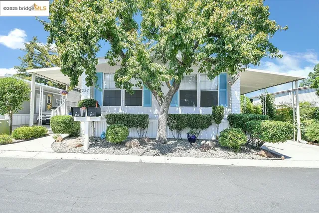 a front view of house with yard and green space