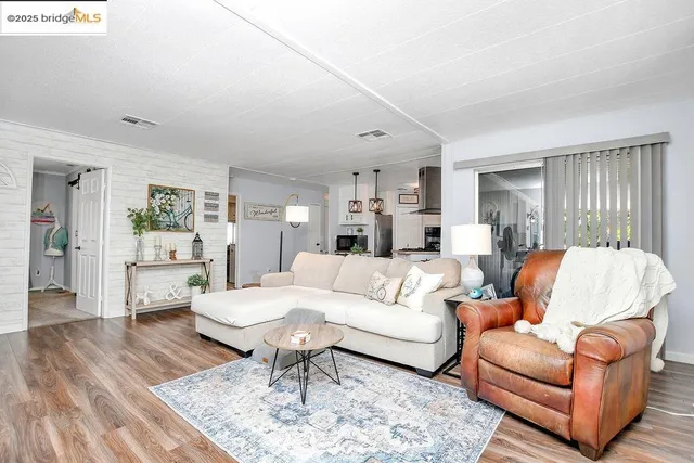 a living room with furniture or couch and a wooden floor