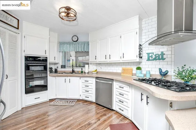 a kitchen with stainless steel appliances a stove and cabinets