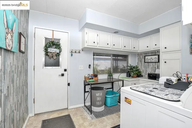 a kitchen with granite countertop white cabinets and white appliances
