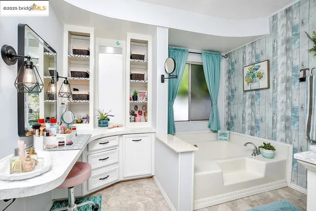 a bath room with a sink tub and a mirror