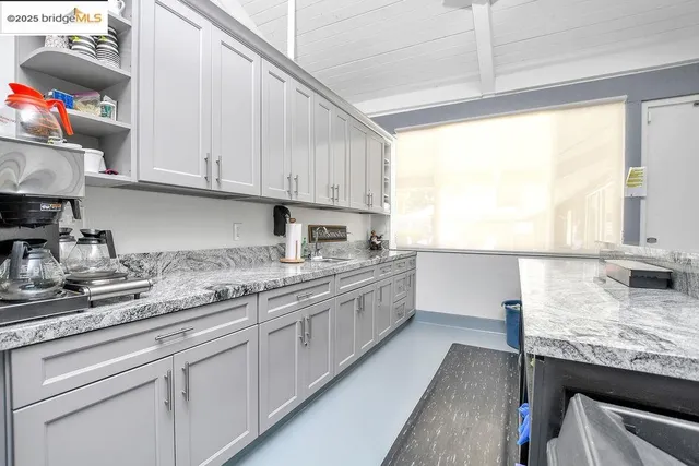 a view of a a dining room with furniture window and wooden floor