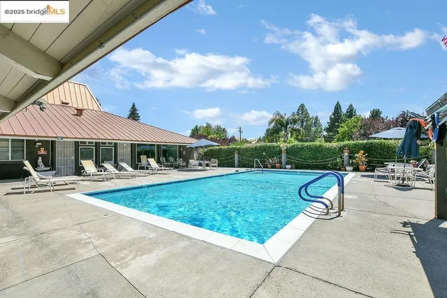 a open kitchen with stainless steel appliances granite countertop a stove a refrigerator a sink and dishwasher