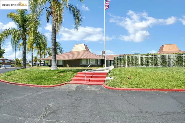 a view of a house with backyard sitting area and garden