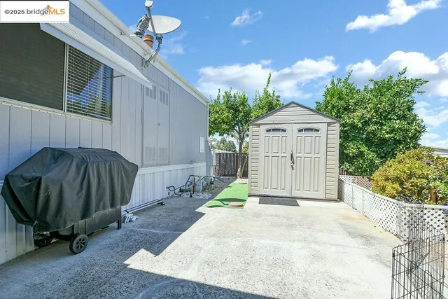 a view of backyard with potted plants and a wooden fence