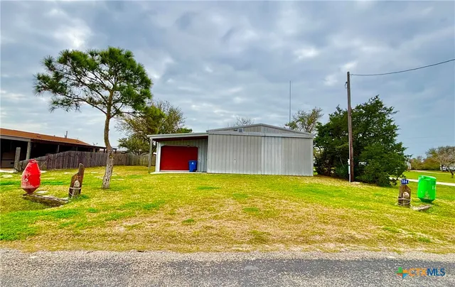a view of a house with a yard and garage