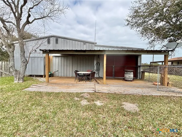 a living room with furniture fireplace and a large window