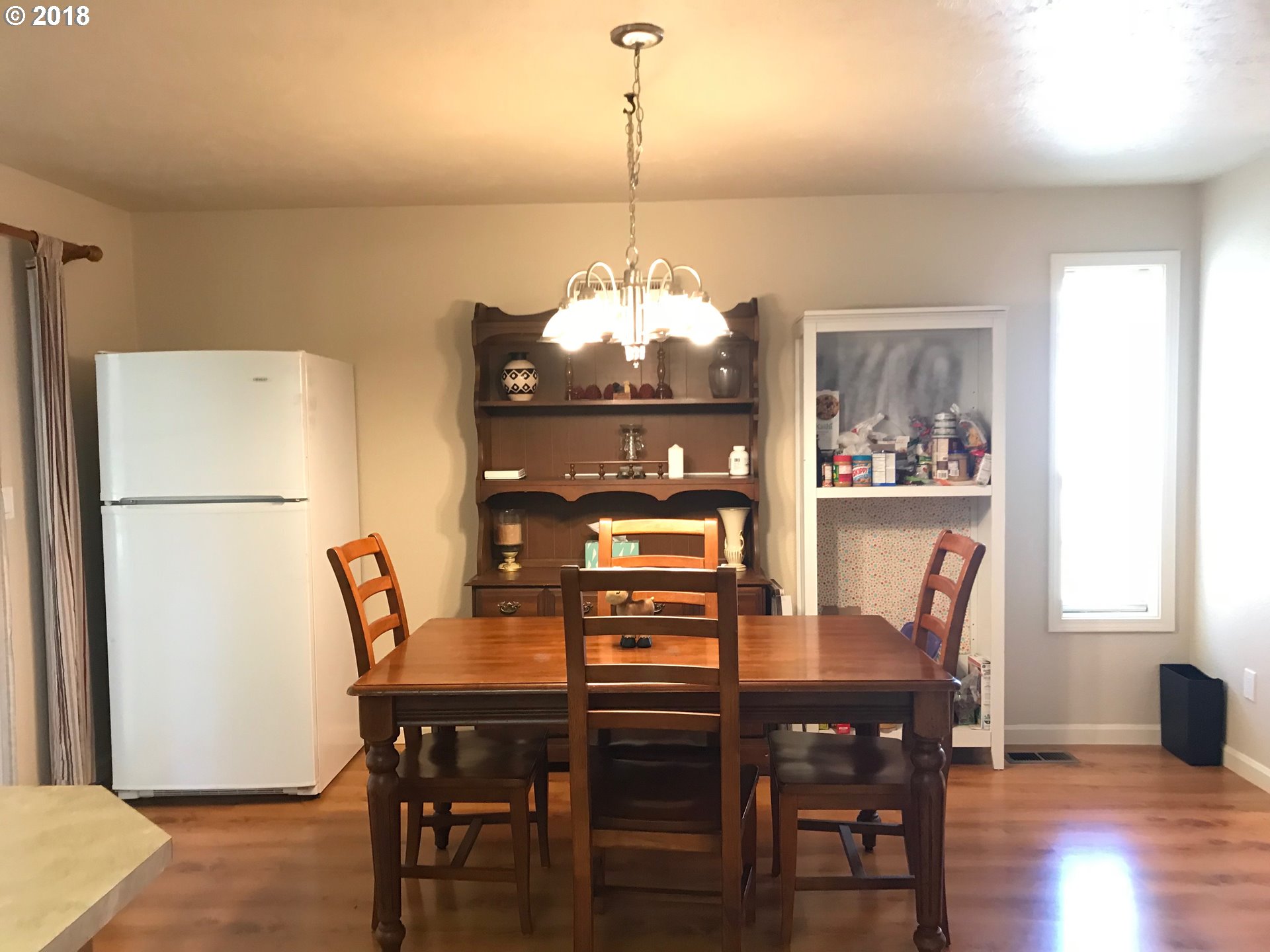 292 72nd Place Springfield, OR 97478 - Photo 3 of 12 a view of a dining room with furniture window and wooden floor