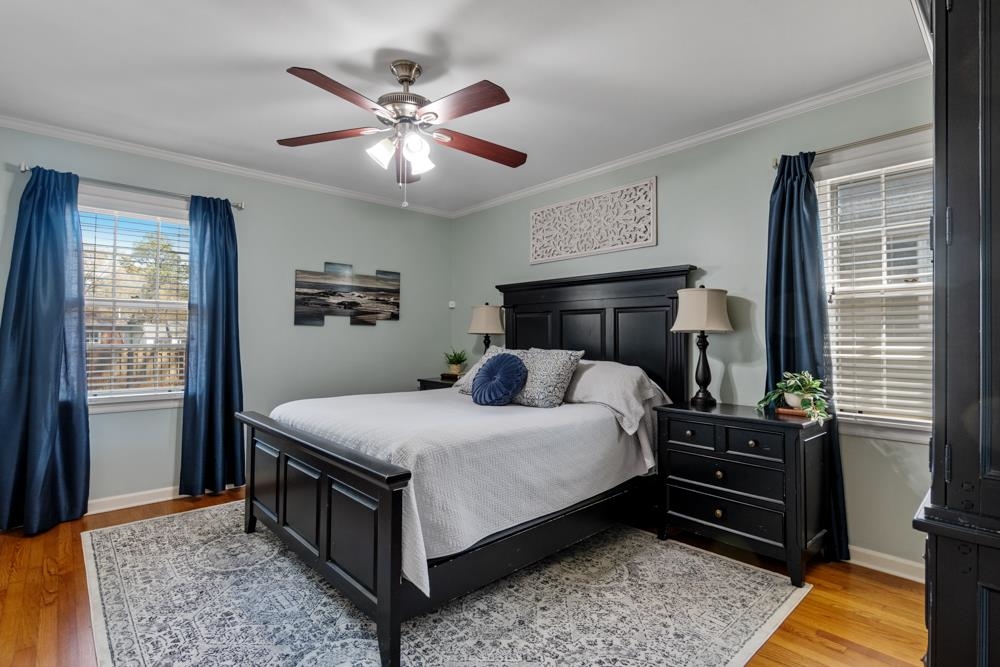 5580 Normandy Road Memphis, TN 38120 - Photo 13 of 25 a bedroom with a bed and wooden floor