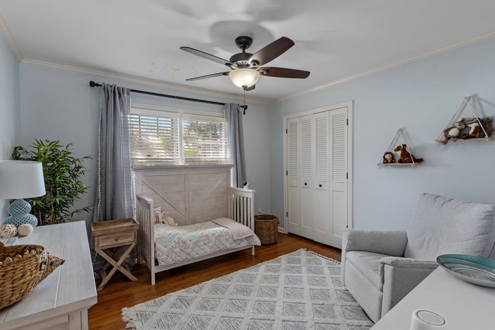5580 Normandy Road Memphis, TN 38120 - Photo 16 of 25 a bedroom with a bed and a chandelier