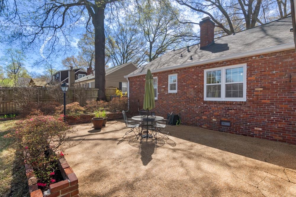 5580 Normandy Road Memphis, TN 38120 - Photo 22 of 25 a view of a patio with table and chairs with wooden fence and plants