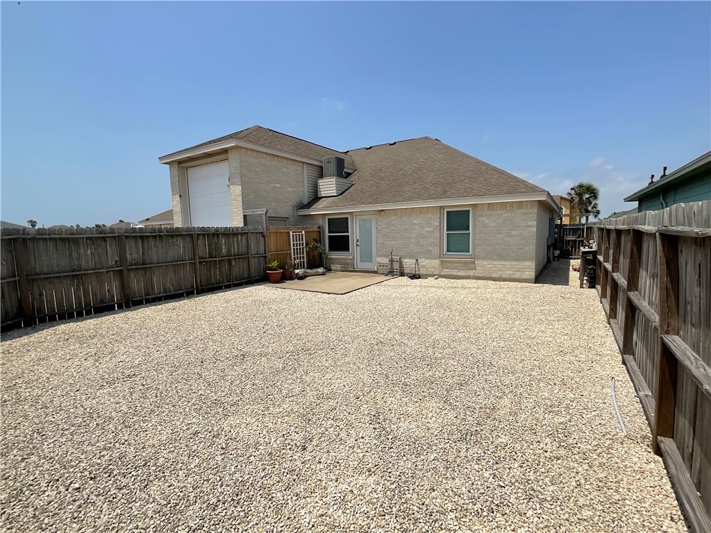 15330 Cruiser Street, Unit A Corpus Christi, TX 78418 - Photo 19 of 20 a view of a house with wooden fence