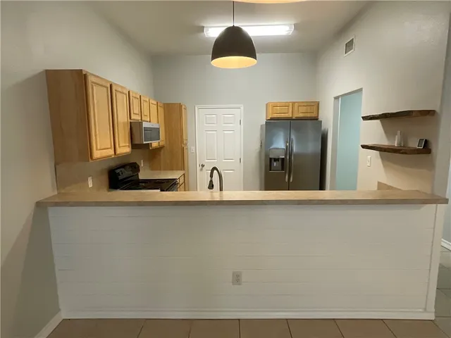 a kitchen with a sink and a refrigerator