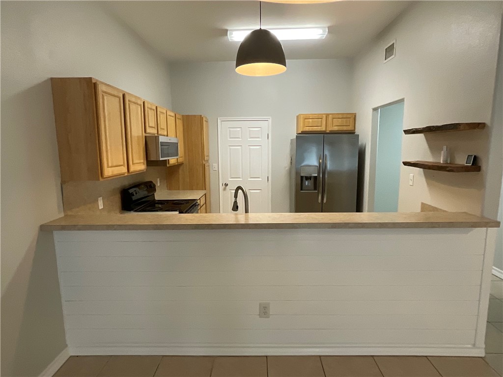 15330 Cruiser Street, Unit A Corpus Christi, TX 78418 - Photo 6 of 20 a kitchen with a sink and a refrigerator