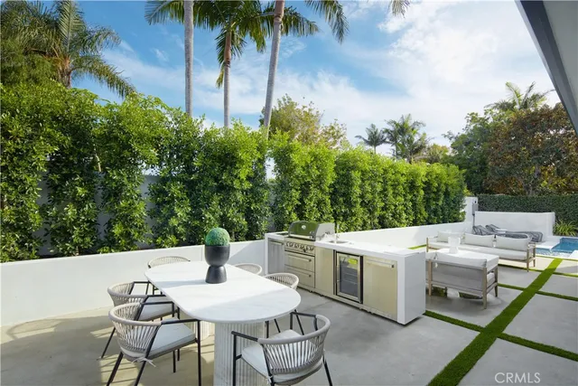 a bedroom with a large bed and a potted plant