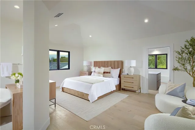 a bedroom with a bed and glass windows