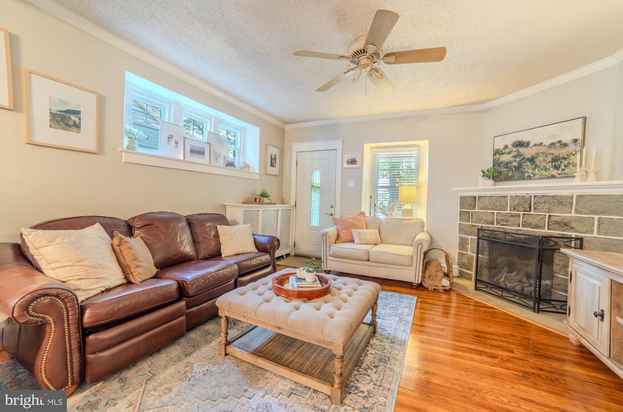 224 Ballymore Road Springfield, PA 19064 - Photo 6 of 38 a living room with furniture a fireplace and a table