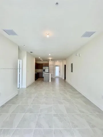 a front view of a house with plants