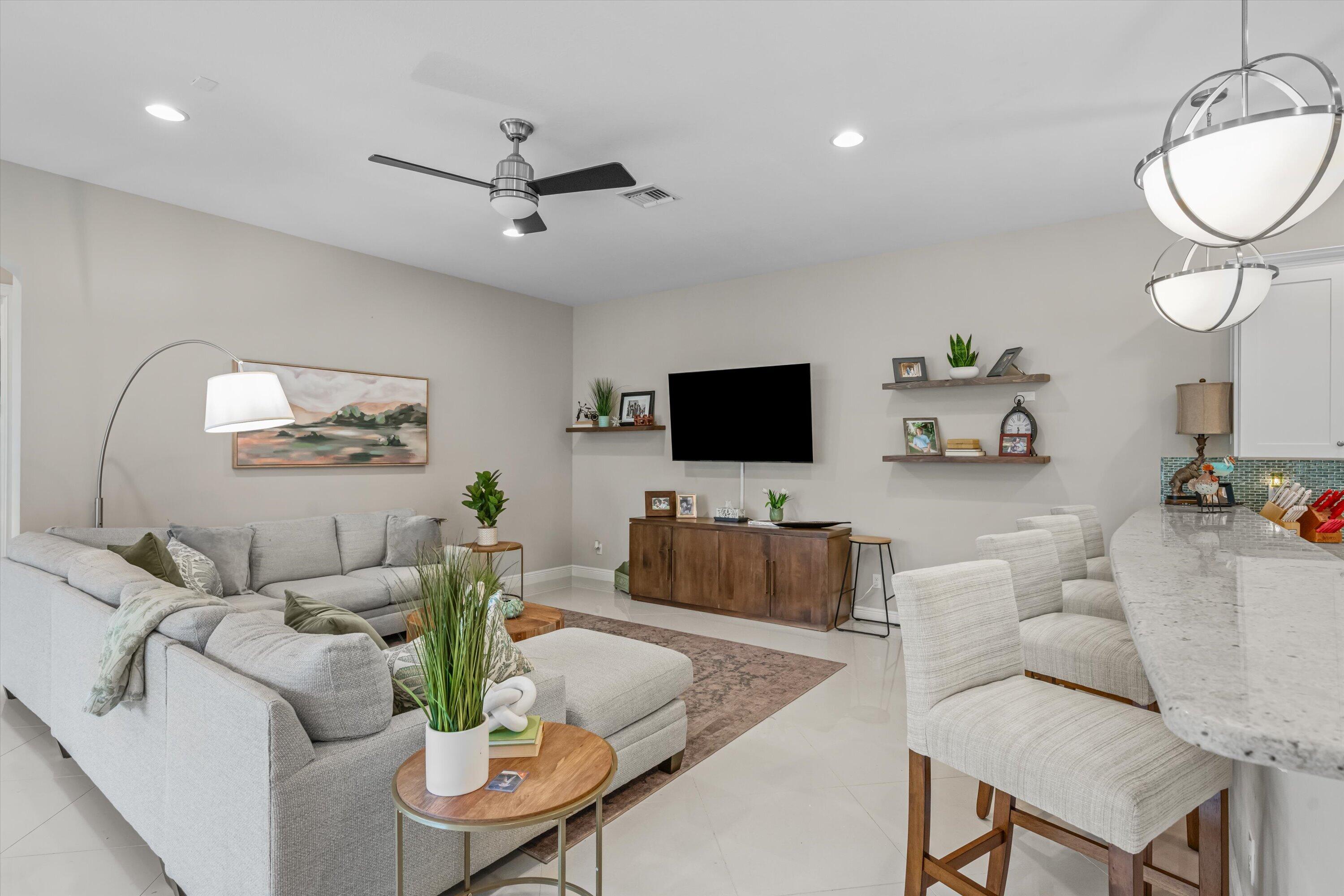 108 Casa Circle Jupiter, FL 33458 - Photo 10 of 53 a living room with furniture and a flat screen tv