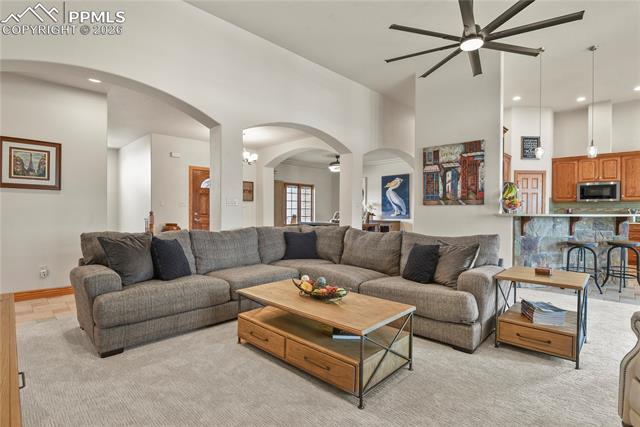 5220 Roundup Ridge Road Colorado Springs, CO 80908 - Photo 7 of 50 Great room with arched entries, tall ceilings, new carpet