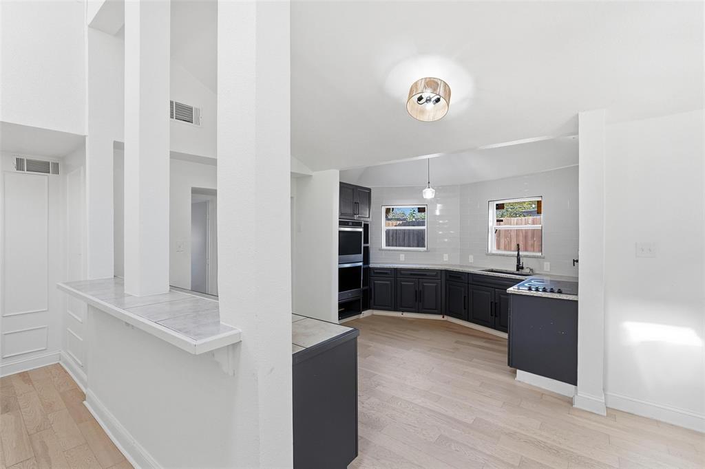 10332 Muskogee Circle Dallas, TX 75217 - Photo 11 of 39 a living room with stainless steel appliances kitchen island granite countertop a refrigerator and a stove top oven