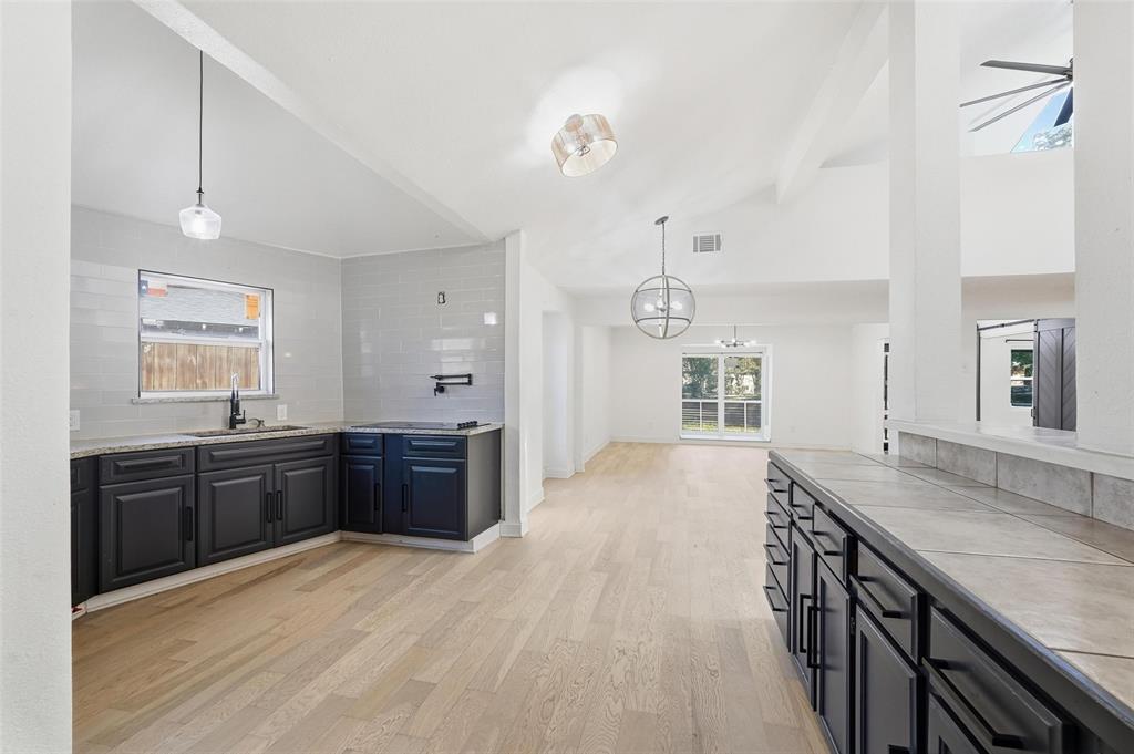 10332 Muskogee Circle Dallas, TX 75217 - Photo 12 of 39 a large kitchen with kitchen island granite countertop lots of counter top space