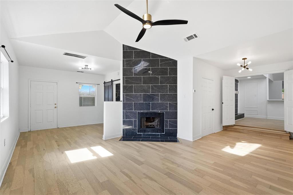 10332 Muskogee Circle Dallas, TX 75217 - Photo 15 of 39 a view of a livingroom with wooden floor a fireplace and window