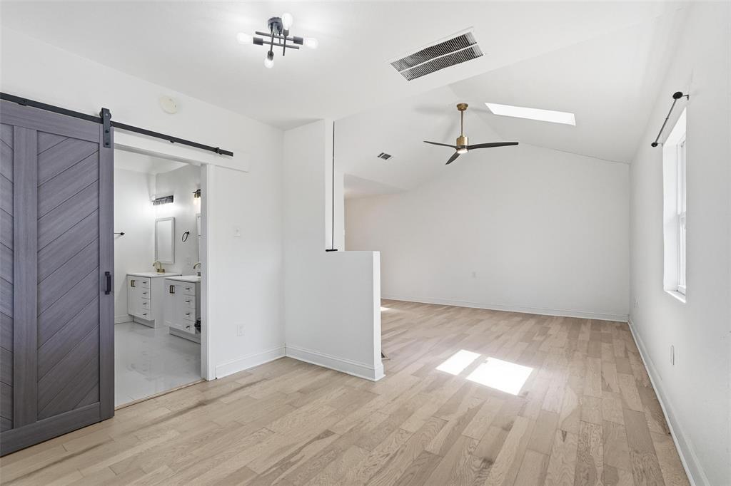 10332 Muskogee Circle Dallas, TX 75217 - Photo 16 of 39 wooden floor in an empty room with a bathroom