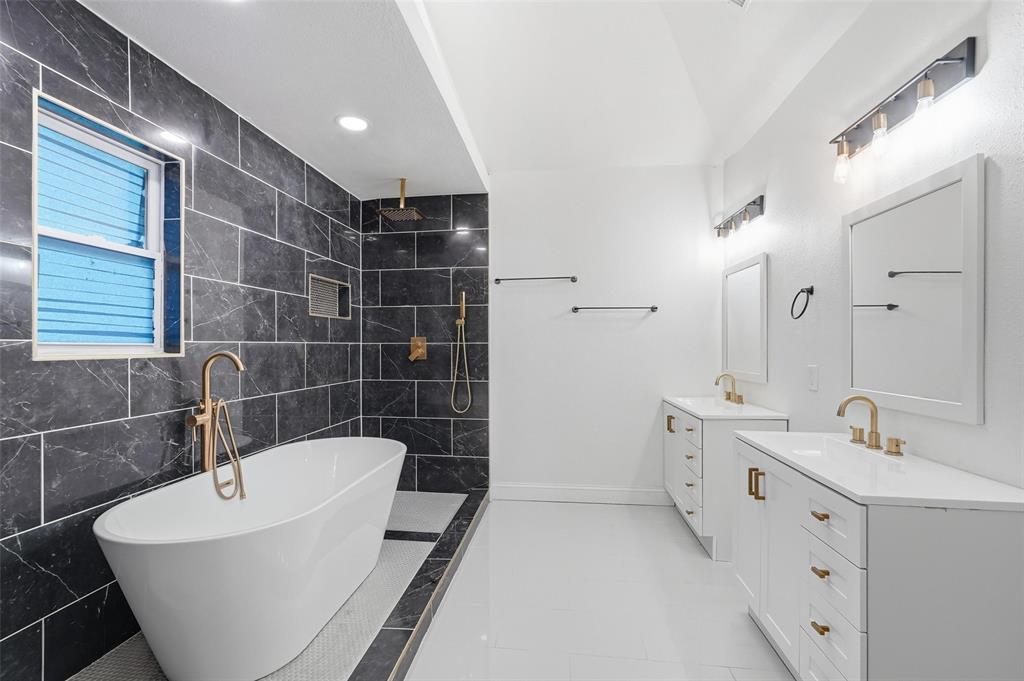 10332 Muskogee Circle Dallas, TX 75217 - Photo 17 of 39 a bathroom with a bathtub and a sink