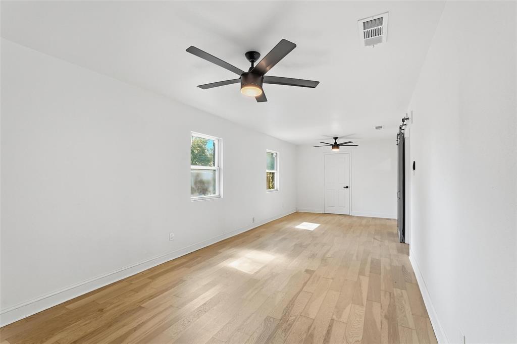 10332 Muskogee Circle Dallas, TX 75217 - Photo 19 of 39 a view of a livingroom with a ceiling fan and wooden floor