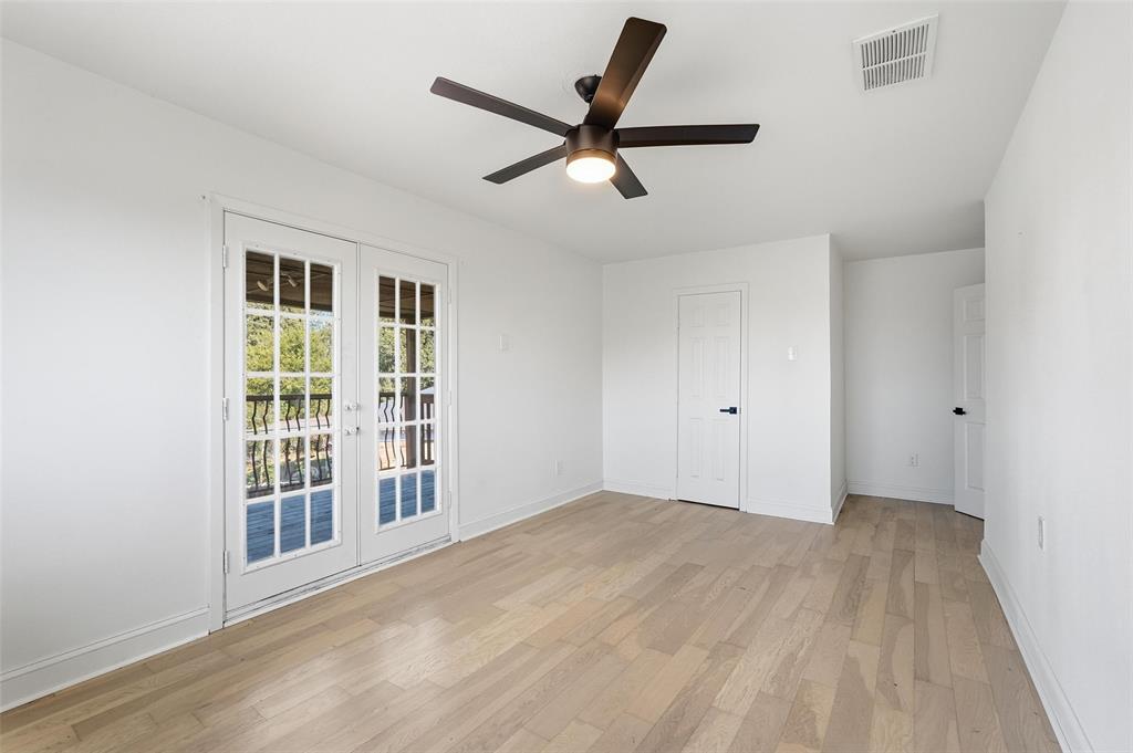 10332 Muskogee Circle Dallas, TX 75217 - Photo 23 of 39 a view of empty room with wooden floor and ceiling fan