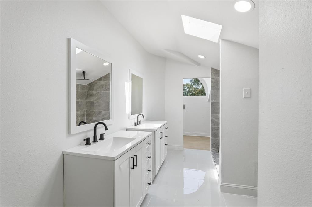 10332 Muskogee Circle Dallas, TX 75217 - Photo 28 of 39 a bathroom with a double vanity sink and mirror