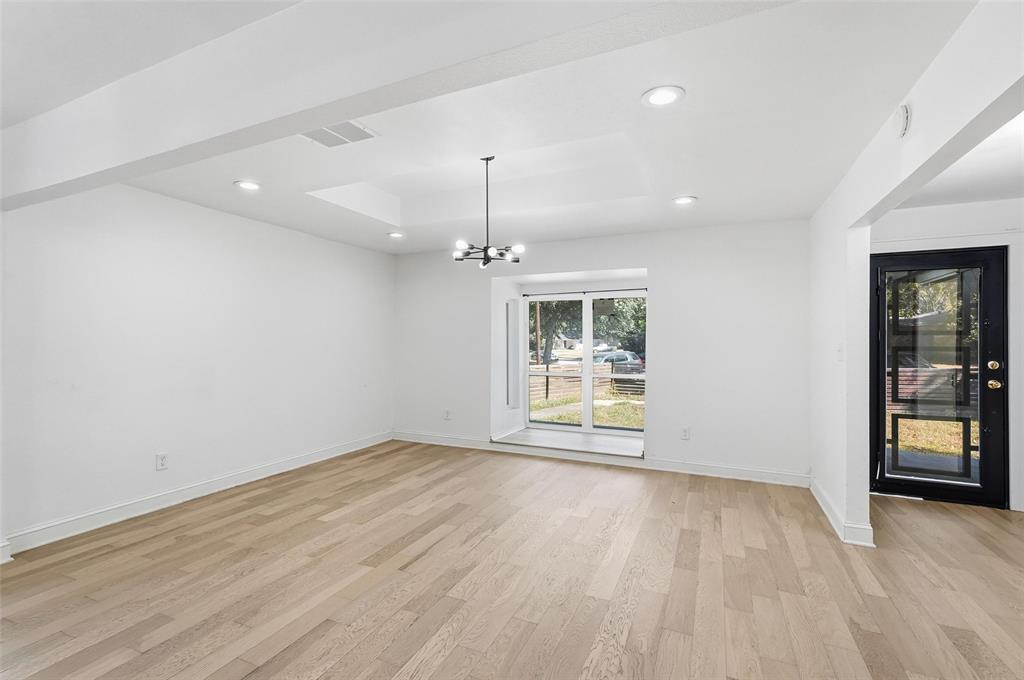 10332 Muskogee Circle Dallas, TX 75217 - Photo 5 of 39 an empty room with wooden floor and windows