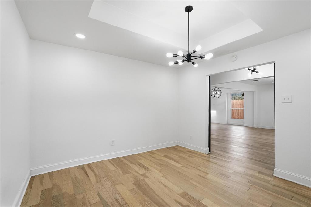 10332 Muskogee Circle Dallas, TX 75217 - Photo 6 of 39 wooden floor in an empty room with a window