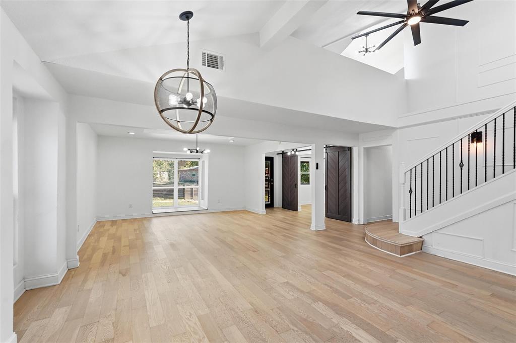 10332 Muskogee Circle Dallas, TX 75217 - Photo 7 of 39 a view of an empty room with wooden floor and windows