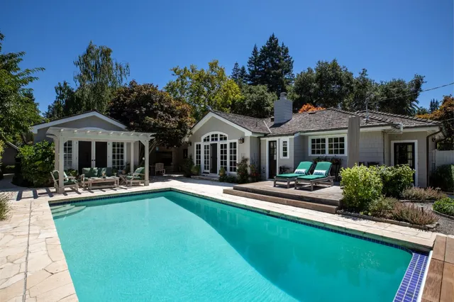 a front view of house with yard and outdoor seating