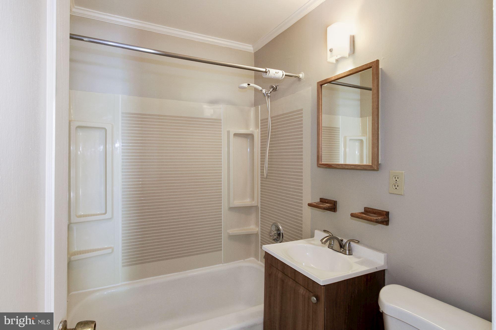 12102 Selfridge Road Silver Spring, MD 20906 - Photo 14 of 22 a bathroom with a sink toilet and shower